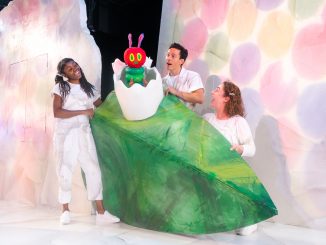 Three actors and a caterpillar puppet